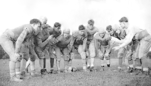 Gallaudet football players huddling up.