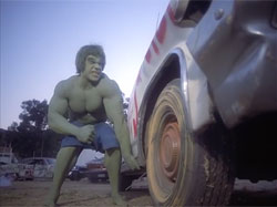 The Incredible Hulk turning over a car.
